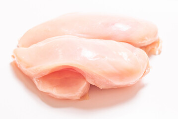 Raw chicken fillet isolated on white background.