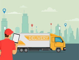 Naklejka premium Delivery courier holds a tablet in his hand with a truck on the background.