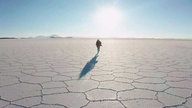 Man in poncho at Salar de Uyuni, Aitiplano, Bolivia. Traveling in Bolivia