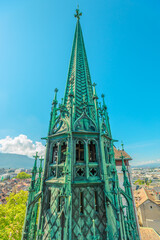 Detail of gothic spire of Saint-Pierre Cathedral in Geneva old town. Roofs of houses and panoramic...