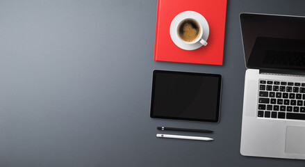Flat lay top view office desk working space with laptop on gray background. Copy space.