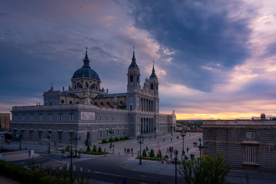 Picturesque Almudena Cathedral with ornamental towers on background of sunset sky in Madrid