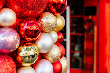 Shop facade with red door decorated with christmas decorative sparkling baubles