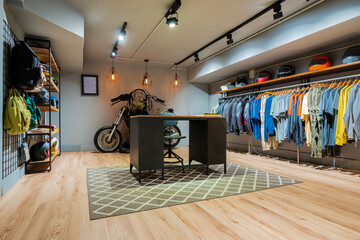 Interior detail of a modern clothing store with hanging clothes