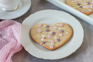 Homemade decorated heart shaped cookies for breakfast on a table