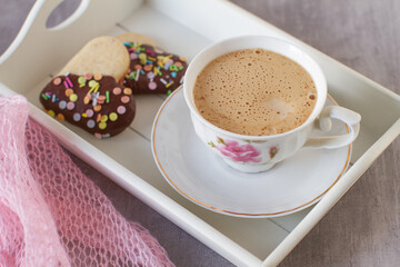 Homemade decorated heart shaped cookies for breakfast on a table