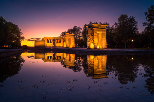 Amazing view of Temple of Debod located near pond in Madrid at sundown