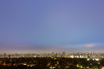 Obraz premium Aerial view of São Paulo city skyline at night, park, streets, houses, trees and buildings in the background at dusk. Concept of urban, city, architecture, cityscape, metropolis, business, tourism.