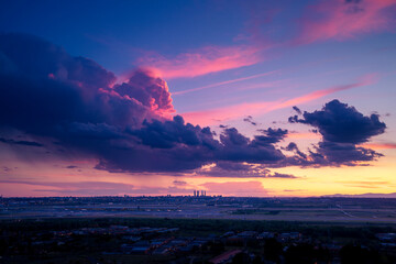 Spectacular scenery of Madrid city under colorful cloudy sky at sundown in Spain