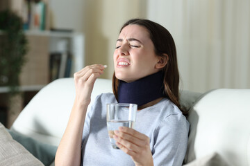 Disabled woman wearing neck brace taking pill