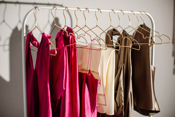 Stylish fashionable women's clothing hangs on a hanger in a store. Clothes for sale