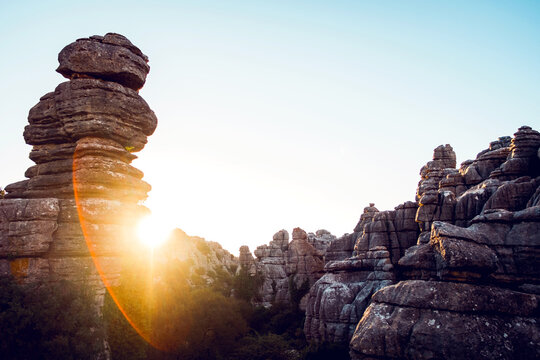 Low angle of unusual rocky formations located in El Torcal de Antequera nature reserve under cloudless blue sky on sunny day