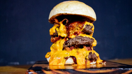 Huge Burger with 3 meats, a lot of cheddar.