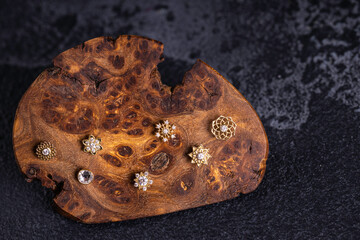 Beautiful piercing jewelry on wooden display. Macro shot. Selective focus.