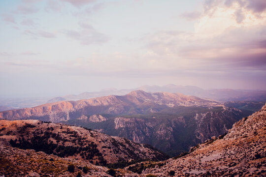 Breathtaking landscape of La Pandera mountain with rocky peaks and green trees located against cloudy sunset sky in Province of Jaen