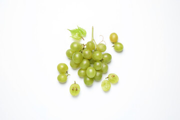 Fototapeta premium Bunch of fresh ripe green grapes with leaf on white background, top view