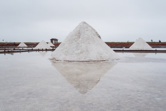 Jingzaijiao Tile paved Salt Fields with dry salt ready for harvesting in cloudy weather in Tainan city in Taiwan