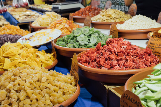 Variety of assorted multicolored yummy sweets in bowls arranged on counter in fairground