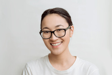 asian young woman wearing glasses for vision on a white background. happy attractive woman smiles