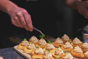 Chefs preparing beautiful dishes in French restaurant's kitchen