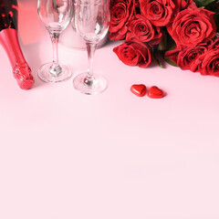 Valentine's day romantic set for two, bouquet of red rose, gift, hearts chocolate sweets, champagne on pink. Greeting card with copy space.