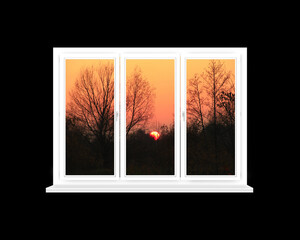 White window with sunset beyond isolated on black background. View from home window