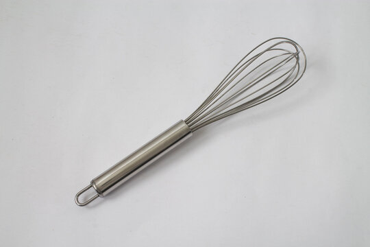 A silver whisk on white background.