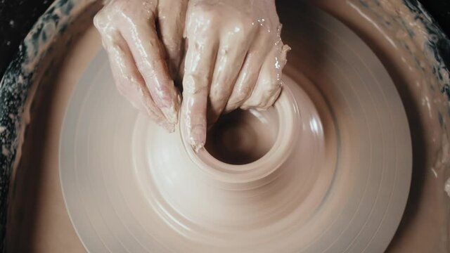 Close up of potter clay wheel, pottery workshop, woman making diy pot to sale in e-commerce store, home hobby