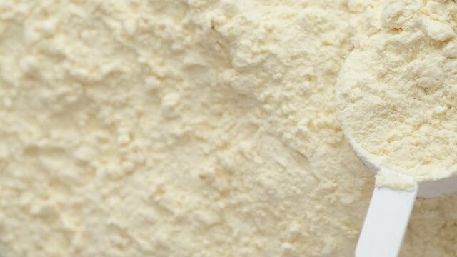 Protein powder and measuring scoop top view.