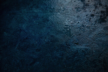 dark blue background, dark wall background. Empty workplace in front of abstract package.