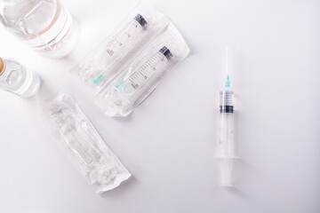 Medical syringes and medicine bottles on a white background.