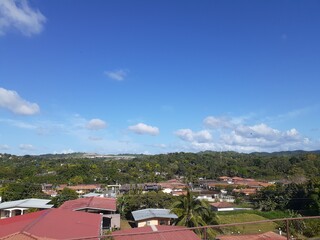 beautiful blue sky with clouds over houses
