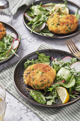 Smoked mackerel fishcakes served with a rocket, spinach salad