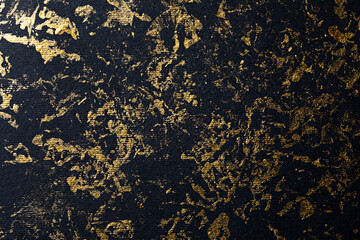 Abstract gold paint on black textured paper