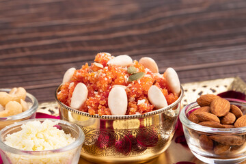 Widely Popular Indian Mithai Gajar Ka Halwa Halva Or Carrot Pudding Halua Made Of Grated Carrots Cream Meetha Mava Sugar Desi Ghee Khoya Mawa And Dry Fruits Badam Decorated And Served In Silver Bowl