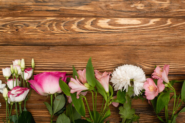 top view of variety of pink and white blooming flowers on wooden surface - Powered by Adobe