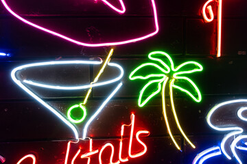 Neon assorted shapes on a black wall. Glowing multi-colored neon.