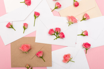 top view of small tea roses on envelopes and letters