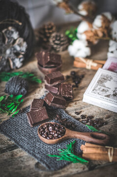 Arrangement of assorted ingredients for chocolate mousse on wooden table in dark room