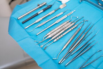 From above of set of various metal tool of sterile table placed in row in dental clinic