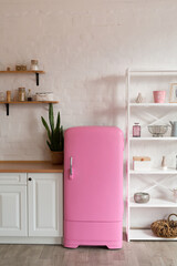 Kitchen shelves, wooden surface and pink fridge on white background. White kitchen interior counter top.