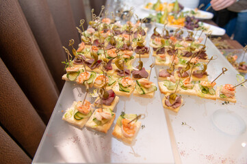 Small appetizer on the served glass table indoors
