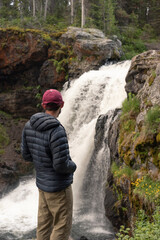 Hiker with Waterfall in Yellowstone National Park