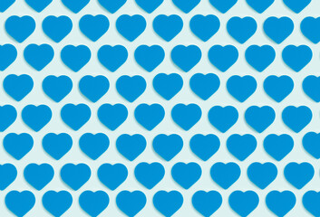 Hearts background. Colored ornament pattern from cut out blue hearts on a blue background. Love, romance, wallpaper, postcard minimal concept