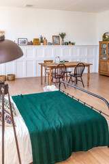 Vintage studio apartment interior in light colors in old style. huge room with large windows with a living room area and a bedroom area. direct sunlight inside.