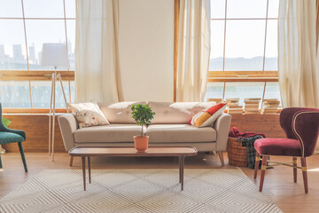 Vintage studio apartment interior in light colors in old style. huge room with large windows with a...