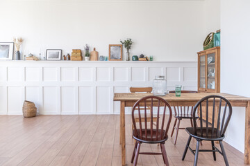 Vintage studio apartment interior in light colors in old style. huge room with large windows with a living room area and a bedroom area. direct sunlight inside.