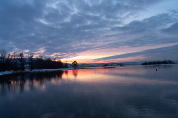 Spectacular winter sunset on the shores of the Upper Zurich Lake (Obersee) near Rapperswil, St. Gallen, Switrzerland