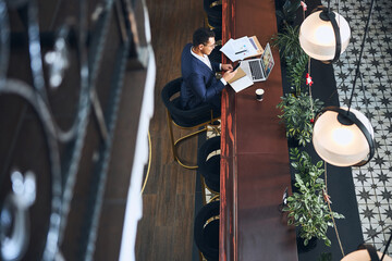 Male student getting distracted from virtual learning