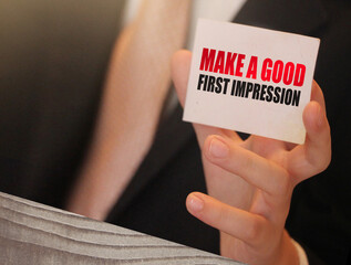 Make a good first impression on a card Businessman holding. Motivation and personal coaching concept
